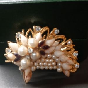 A set of a pin and clasp earrings